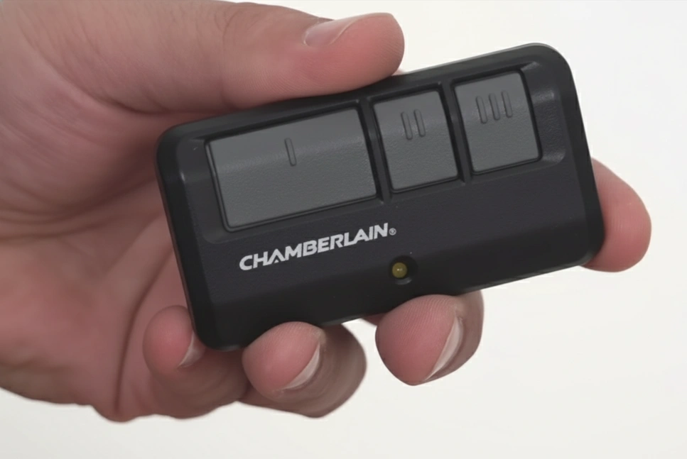 Chamberlain 3-button garage door remote held in hand